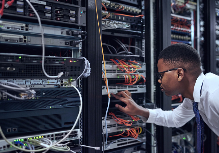 IT technician working on server rack